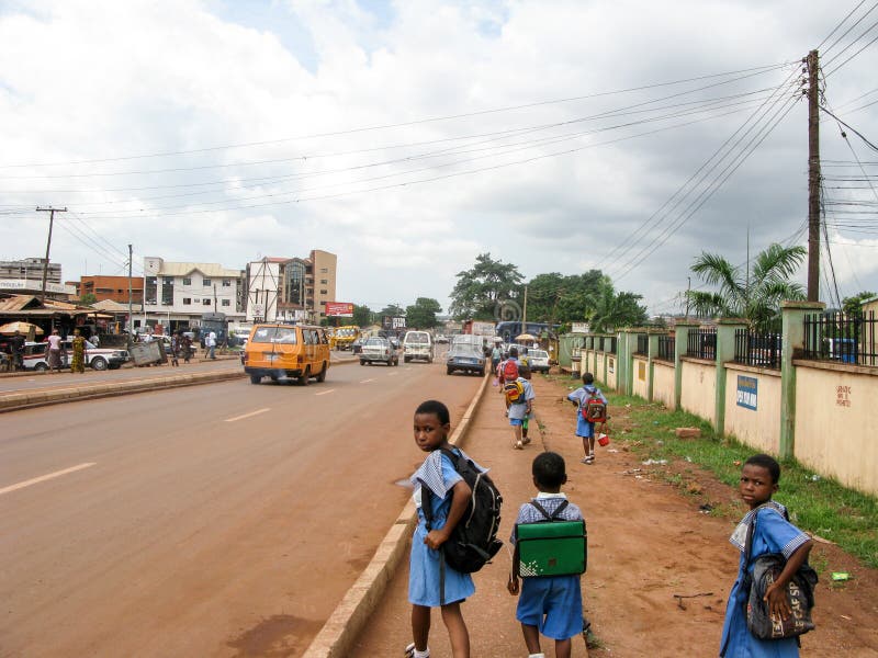 Nigerian street with school kids and cars