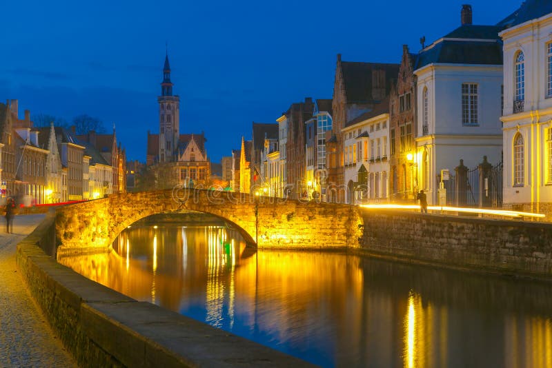 Scenic night cityscape with views of Spiegelrei, Canal Spiegel, bridge and church in Bruges, Belgium. Scenic night cityscape with views of Spiegelrei, Canal Spiegel, bridge and church in Bruges, Belgium