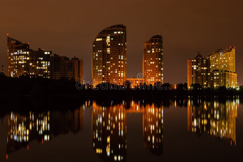 Night city with reflection of houses in the river