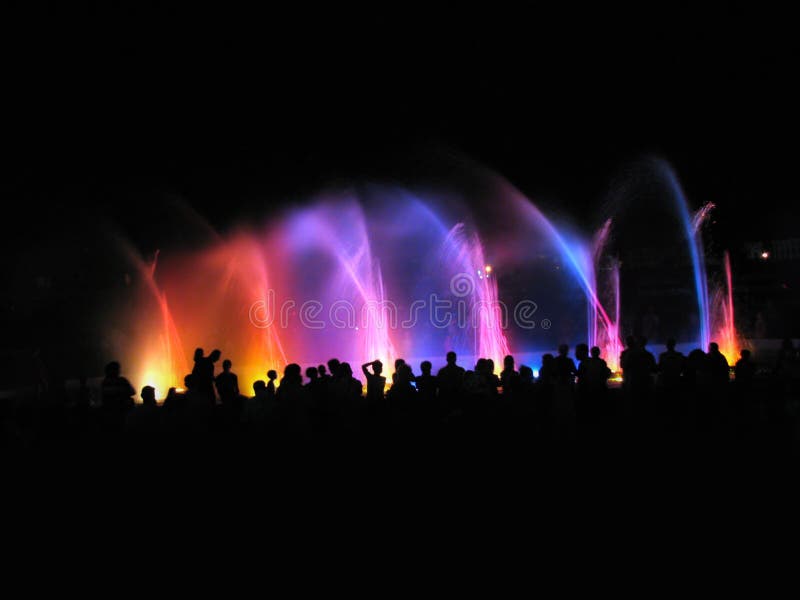 Night club party; people near fountain in night. Disco violet light stock images, royalty-free photos and pictures