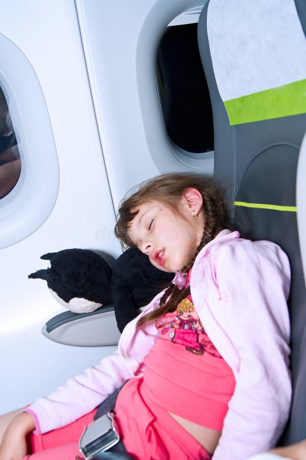 A child is sleeping in the plane during a flight