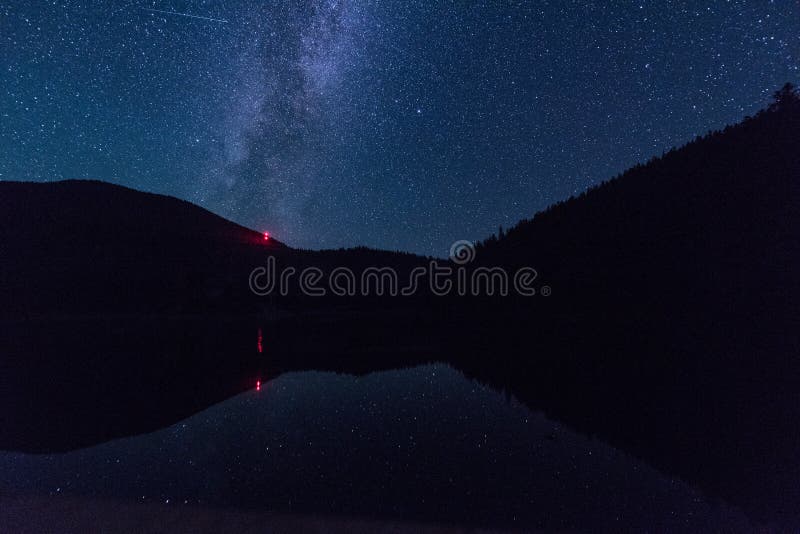 Night landscape with starry sky and Milky Way during Perseid meteor shower over the alpine lake Synevyr in Carpathian mountains stock images Night landscape with starry sky and Milky Way during Perseid meteor shower over the alpine lake Synevyr in Carpathian mountains stock images