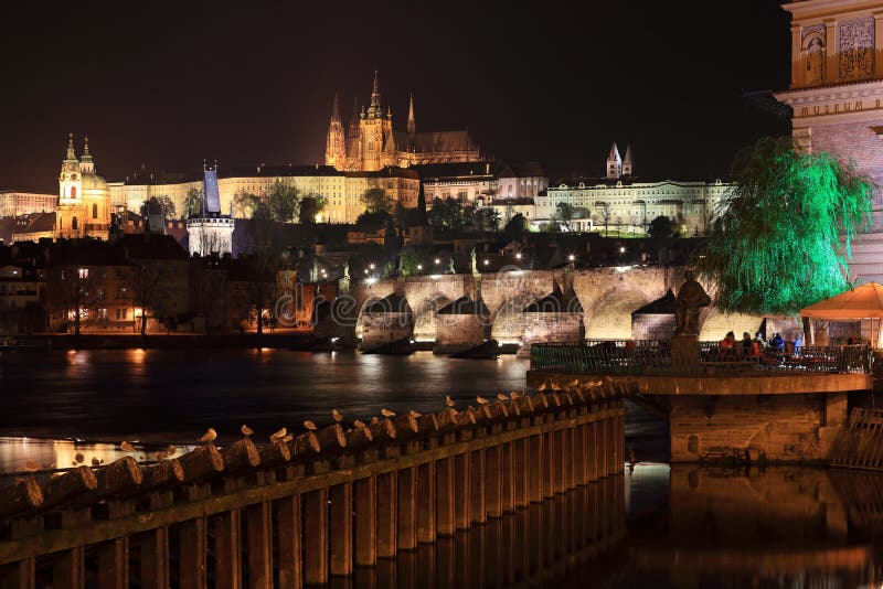 Colorful night Prague gothic Castle and St. Nicholas' Cathedral with Charles Bridge, Czech Republic