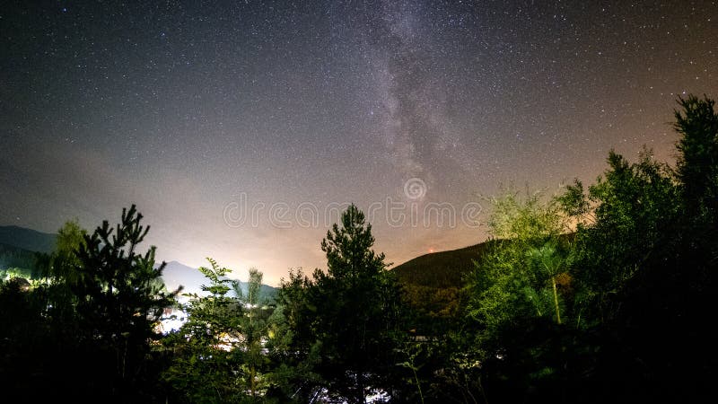 Night stars and milky way galaxy above slovakian village