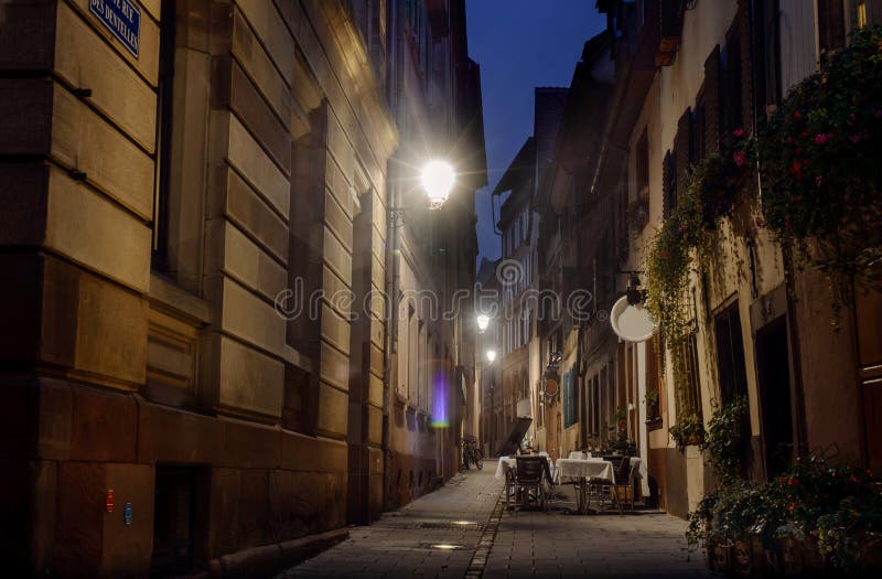 Night Street Strasbourg lit streetlights cozy cafe in an alley