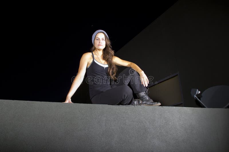 Free runner scaling or climbing a wall at night to do parkour. Female climbing high risk building stock images, royalty-free photos and pictures