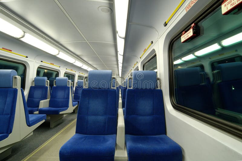 Vacant seats inside a train during evening hours. All names and logos removed and only general warning signs remain. Night train stock images, royalty-free photos and pictures