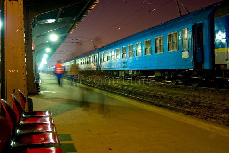 Train station at night showing motion blur of people walking by. Horizontal orientation. Night train stock images, royalty-free photos and pictures