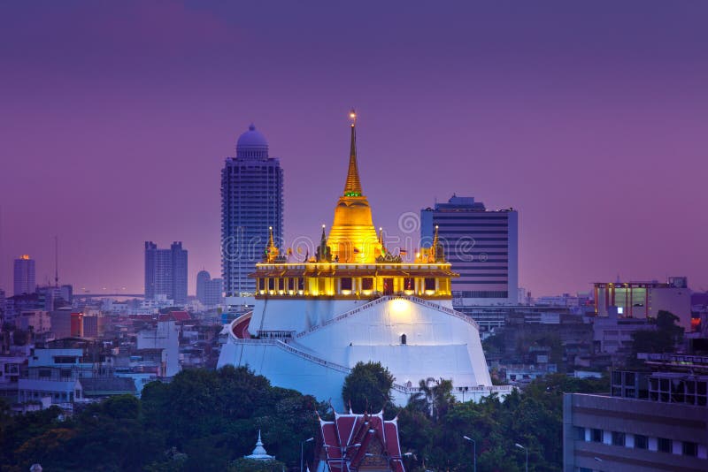 Night Urban City Skyline, Saket Temple (Golden mountain), Landmark of Bangkok, Thailand.