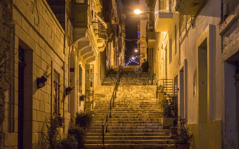 Night View On A Alleyway With Many Steps Lights And Handrail Covered By Old House Fronts Some Flowers In The Pot Located In Malt Stock Photo Image Of Lights Clothes