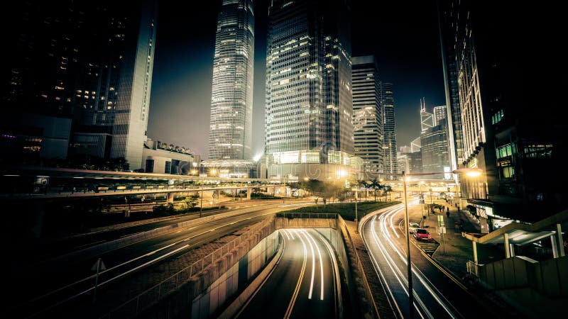 Night view of modern city traffic across street. Time lapse. Hong Kong