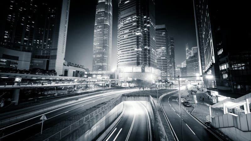 Night view of modern city traffic across street. Time lapse. Hong Kong