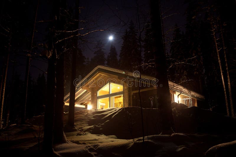 Night view of wooden cottage.