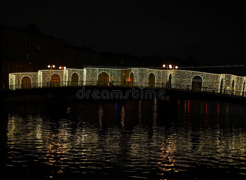 Nighttime Glow: A Bridge Draped in Twinkling Lights stock photography