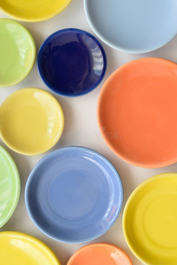 Colorful Plates of Different Color and Sizes. Tabletop. Stock Photo