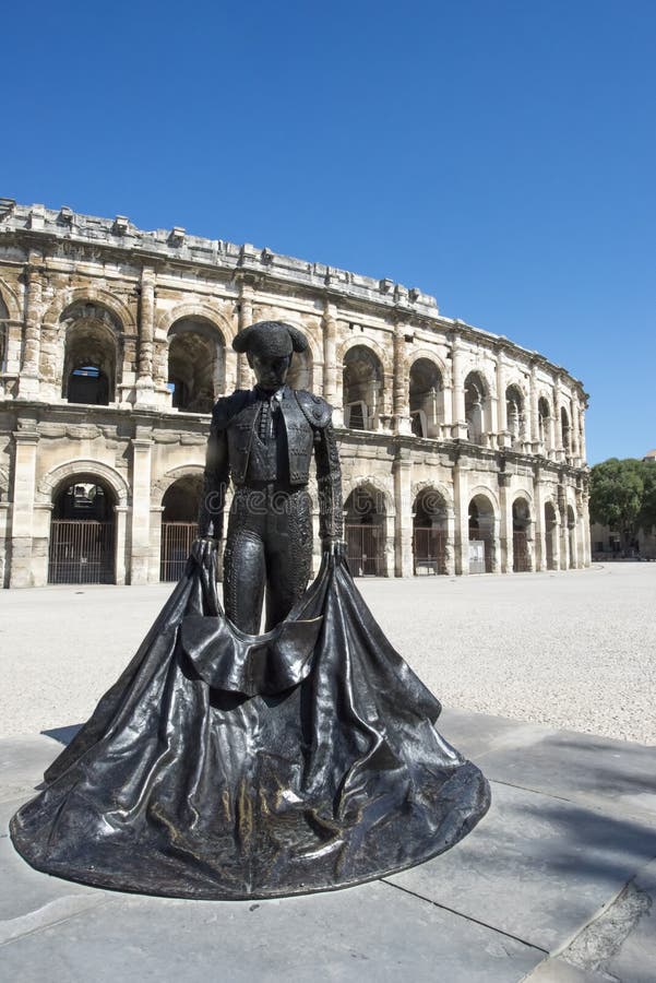 The statue of the famous matador Nimeño II in front of the arena of Nîmes. The Arena of Nîmes is a Roman amphitheatre, situated in the French city of Nîmes. Built around AD 70, it was remodelled in 1863 to serve as a bullring. The Arenas of Nîmes is the site of two annual bullfights during the Feria de Nîmes, and it is also used for other public events. The statue of the famous matador Nimeño II in front of the arena of Nîmes. The Arena of Nîmes is a Roman amphitheatre, situated in the French city of Nîmes. Built around AD 70, it was remodelled in 1863 to serve as a bullring. The Arenas of Nîmes is the site of two annual bullfights during the Feria de Nîmes, and it is also used for other public events.