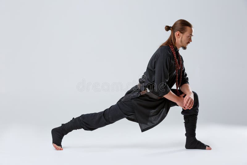 A Ninja Man Pulled His Right Foot Back for Stretching Muscles Against a Gray Background Stock Photo - Image of karate, danger: 105554578 A Ninja Man Pulled His Right Foot Back for Stretching Muscles Against a Gray Background Stock Photo - Image of karate, danger: 105554578