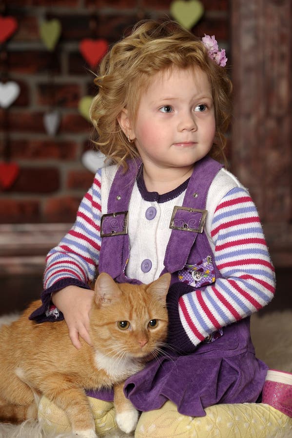 Little girl with a red cat. Little girl with a red cat