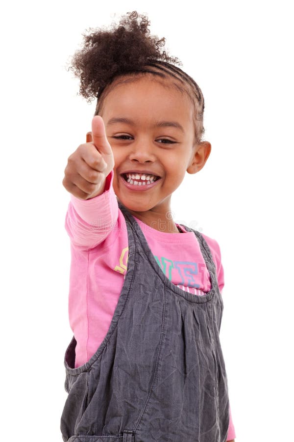 Niña linda que hace los pulgares para arriba fotos de archivo libres de regalías Niña linda que hace los pulgares para arriba fotos de archivo libres de regalías