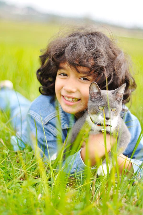 Very cute and beautiful little girl with cat on the meadow. Very cute and beautiful little girl with cat on the meadow