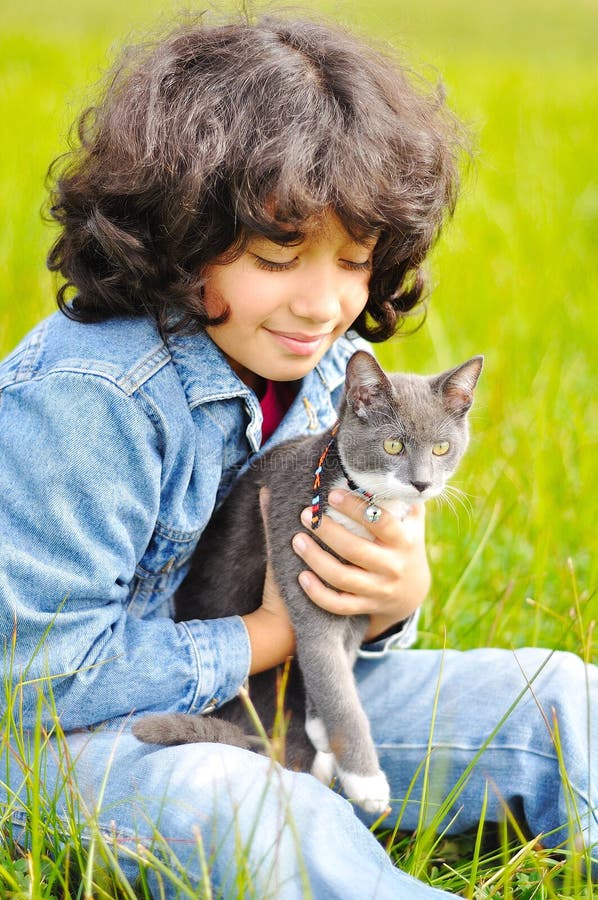 Very cute little girl with her cat on the meadow. Very cute little girl with her cat on the meadow