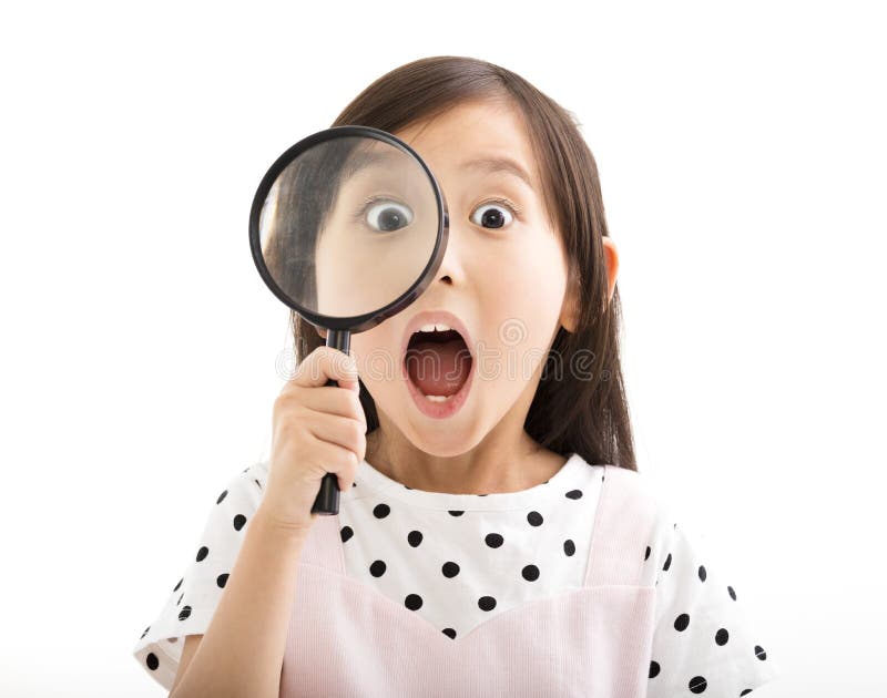 Little girl looking through a magnifying glass. Little girl looking through a magnifying glass