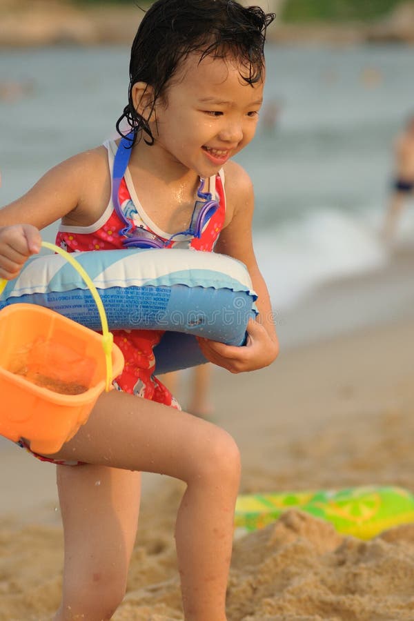 A Chinese little kid playing on the beach. A Chinese little kid playing on the beach