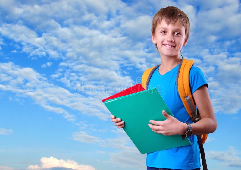 Happy smiling schoolkid with backpack against blue cloudy sky. Happy smiling schoolkid with backpack against blue cloudy sky