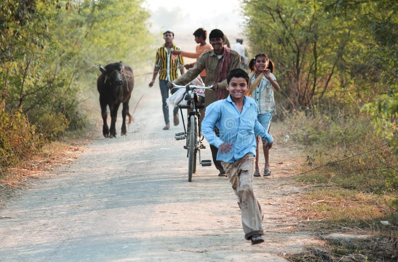 Photograph of a Runing Child to see a photographer, His Father and sister also happy in background.rnHe's father are farmer and come back from field..rnHe Live happiness with 4 person in family.rnLike to talk him. Photograph of a Runing Child to see a photographer, His Father and sister also happy in background.rnHe's father are farmer and come back from field..rnHe Live happiness with 4 person in family.rnLike to talk him.