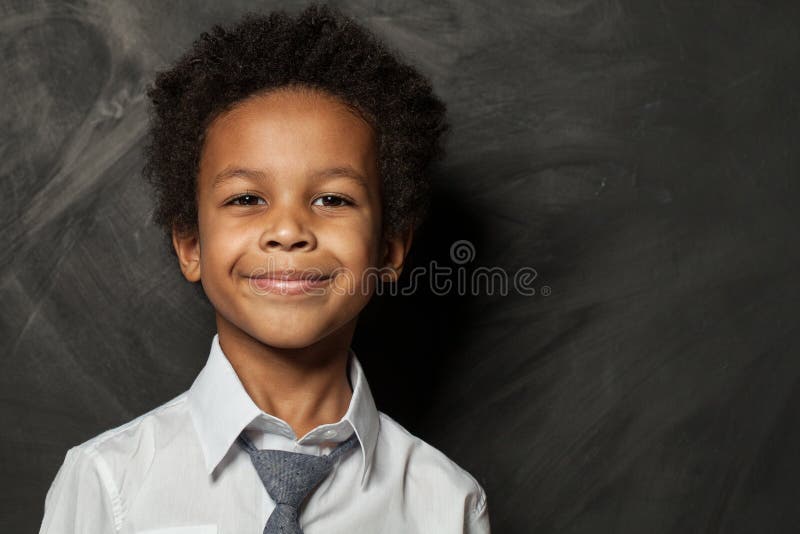 Happy kid boy on blackboard background. Smiling child face close up portrait. Happy kid boy on blackboard background. Smiling child face close up portrait.