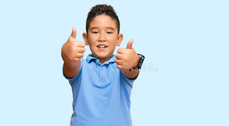 Little boy hispanic kid wearing casual clothes success sign doing positive gesture with hand, thumbs up smiling and happy. cheerful expression and winner gesture. Little boy hispanic kid wearing casual clothes success sign doing positive gesture with hand, thumbs up smiling and happy. cheerful expression and winner gesture