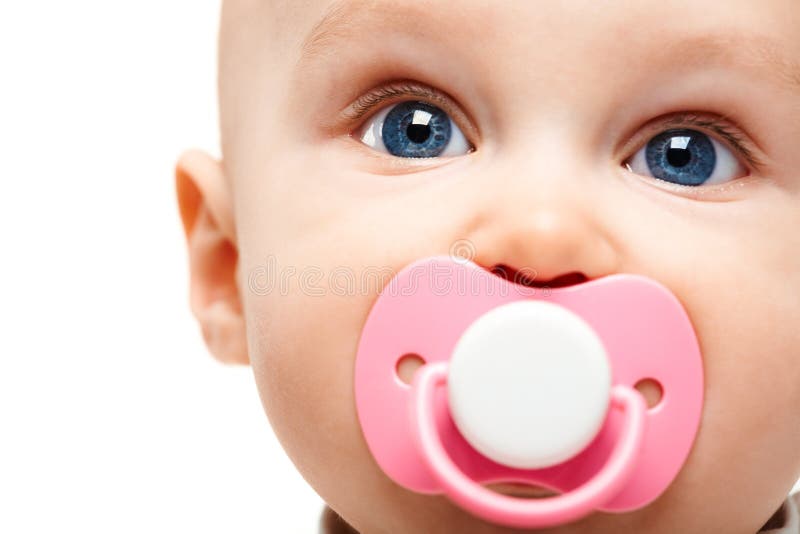 Face of adorable baby with pacifier in mouth looking at camera. Face of adorable baby with pacifier in mouth looking at camera