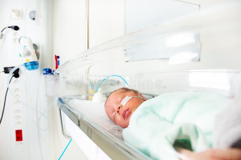 Close portrait of premature child sleeping and being with feeding milk through nose in ICU in hospital. Close portrait of premature child sleeping and being with feeding milk through nose in ICU in hospital