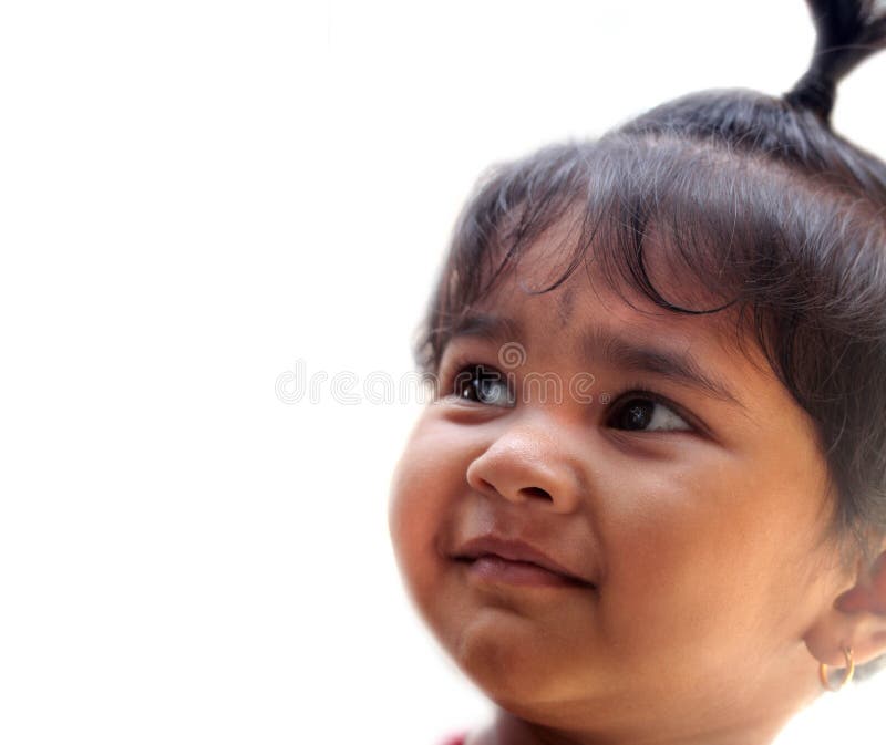 Happy smiling indian kid or child smiling and looking up like daydreaming orr wishing for something and image of the girl isolated on white background. Happy smiling indian kid or child smiling and looking up like daydreaming orr wishing for something and image of the girl isolated on white background