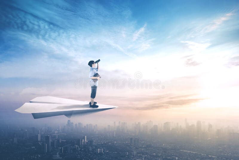 Picture of little boy standing on a paper aeroplane while flying above city and looking with binoculars. Picture of little boy standing on a paper aeroplane while flying above city and looking with binoculars