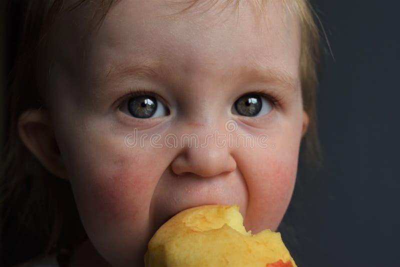 Niño que come una manzana imágenes de archivo libres de regalías Niño que come una manzana imágenes de archivo libres de regalías