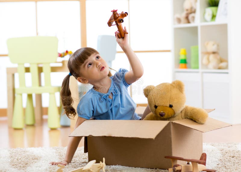 Kid girl playing with plane toy at home. Travel, freedom and imagination concept. Kid girl playing with plane toy at home. Travel, freedom and imagination concept.