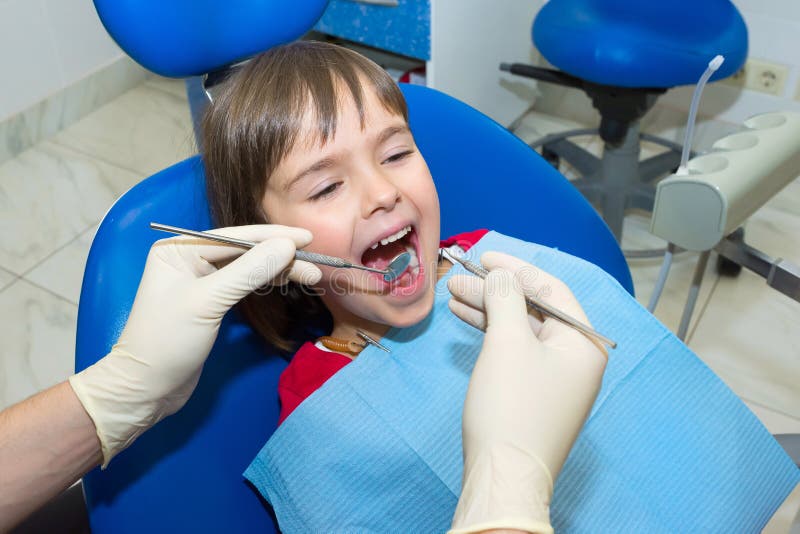 Child having teeth examined at dentists. Healthcare and medical. Closeup. Child having teeth examined at dentists. Healthcare and medical. Closeup.