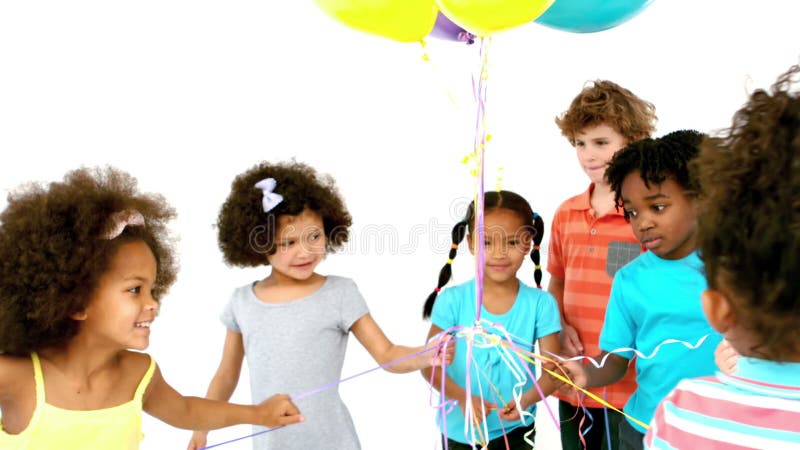 Niños felices que juegan con los globos