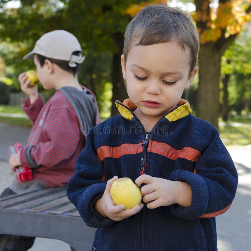 Niños que comen la manzana imágenes de archivo libres de regalías Niños que comen la manzana imágenes de archivo libres de regalías