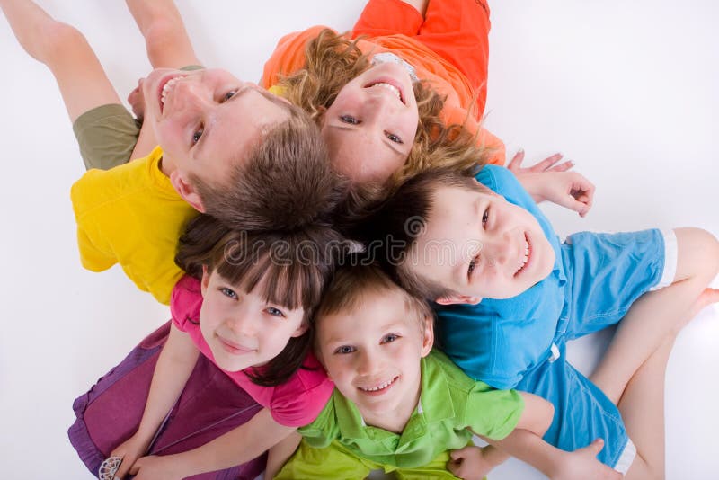 Five caucasian happy smiling kids sitting in a circle on the floor and looking up. Five caucasian happy smiling kids sitting in a circle on the floor and looking up.