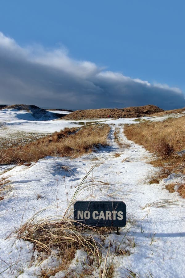 No carts sign on a snow covered links golf course