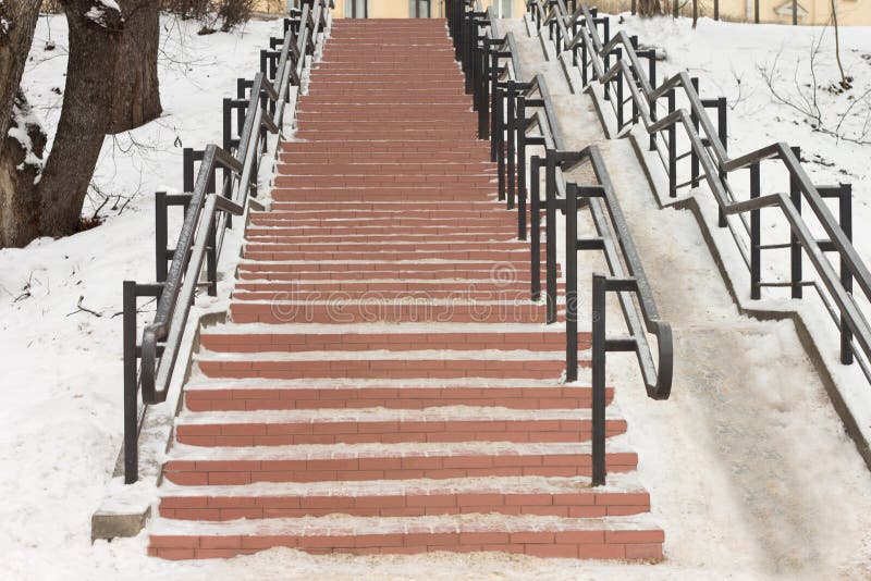 No centro da cidade no parque há uma escadaria de pedra com trilhos do ferro fotos de stock No centro da cidade no parque há uma escadaria de pedra com trilhos do ferro fotos de stock