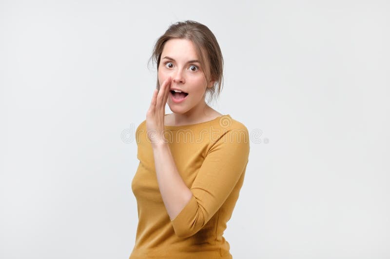 No diga a cualquier persona el concepto El adolescente hablador en suéter amarillo está diciendo las noticias secretas que miran fotografía de archivo libre de regalías No diga a cualquier persona el concepto El adolescente hablador en suéter amarillo está diciendo las noticias secretas que miran fotografía de archivo libre de regalías