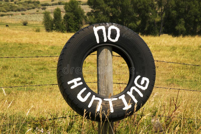 No Hunting on a Tire outside of Medicine Bow National Forest, Wy royalty free stock image No Hunting on a Tire outside of Medicine Bow National Forest, Wy royalty free stock image