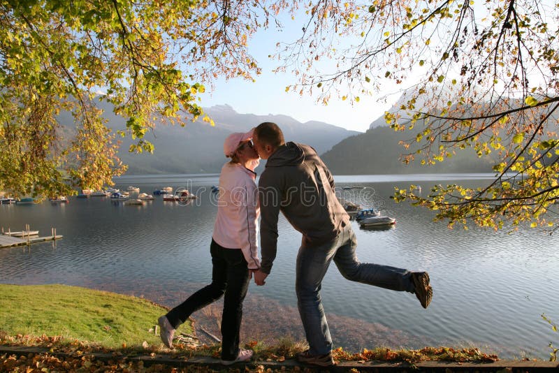 Panoramic view of the lake WÃ¤gital in Swiss Alps, the couple kiss in the evenings sunrays. Panoramic view of the lake WÃ¤gital in Swiss Alps, the couple kiss in the evenings sunrays