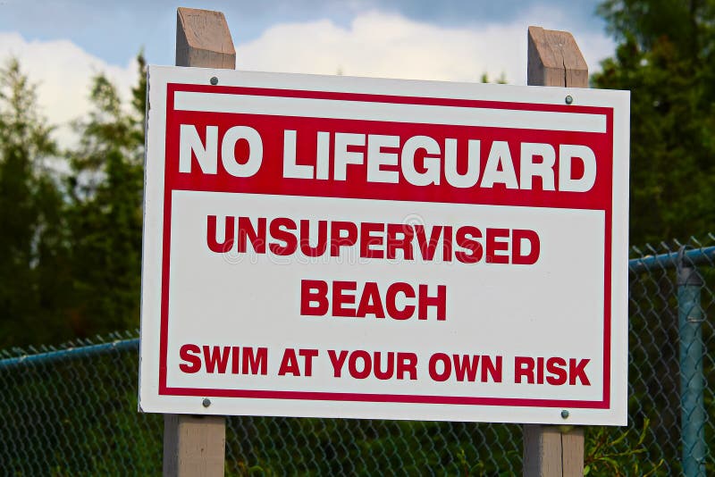 A No Lifeguard Unsupervised Beach Use at Own Risk Sign Stock Photo ...