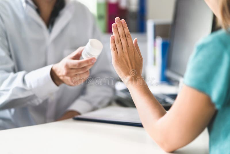 No medicine. Patient refusing to use medication. Bad side effects of tablets. Doctor or pharmacist giving pills. Woman decline. Mistake by nurse or physician royalty free stock image No medicine. Patient refusing to use medication. Bad side effects of tablets. Doctor or pharmacist giving pills. Woman decline. Mistake by nurse or physician royalty free stock image