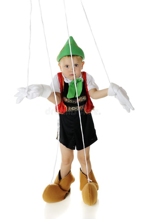 An adorable preschool child playing a Pinocchio puppet, strings and all. He's shrugging his shoulders in an I don't know gesture. On a white background. Little marionette stock images, royalty-free photos and pictures