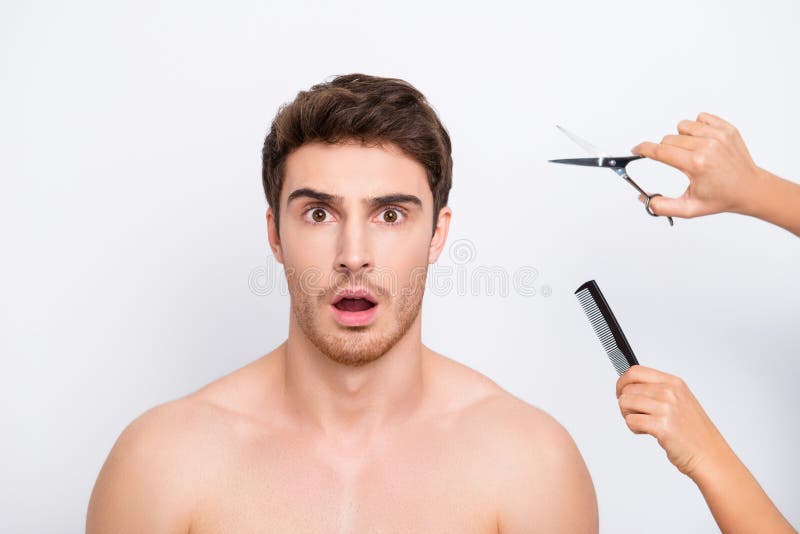 Wow omg! I don`t want to follow the fashion! Close up portrait of amazed impressed with open mouth bristle stubble handsome man and hands giving hairdresser`s tools isolated on gray background. Wow omg! I don`t want to follow the fashion! Close up portrait of amazed impressed with open mouth bristle stubble handsome man and hands giving hairdresser`s tools isolated on gray background